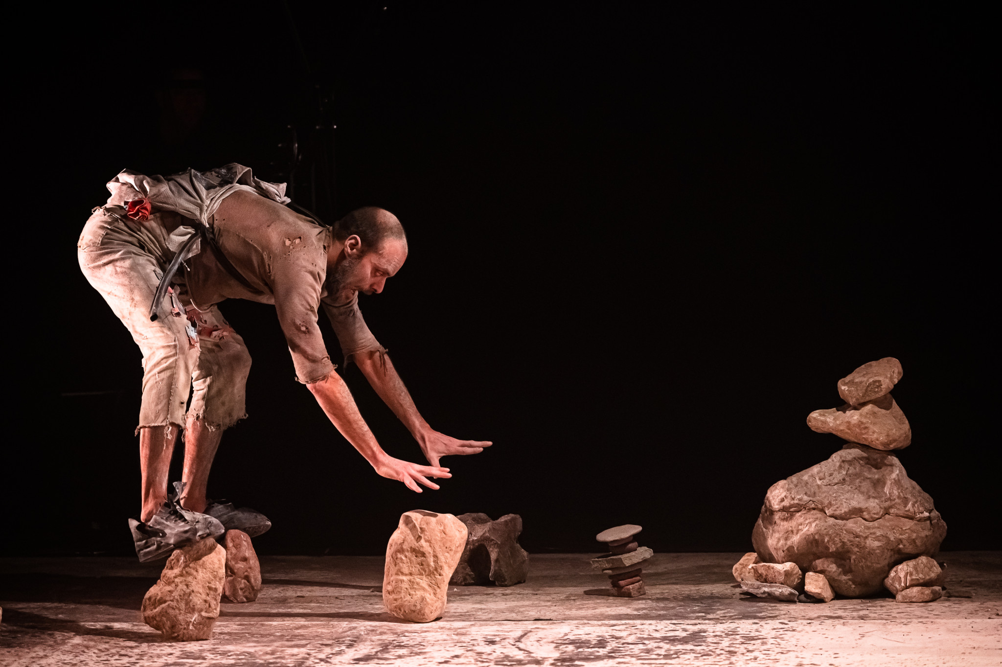 Alessandro Maida balancing on stones. Magda Clan, @ Donato Aquaro